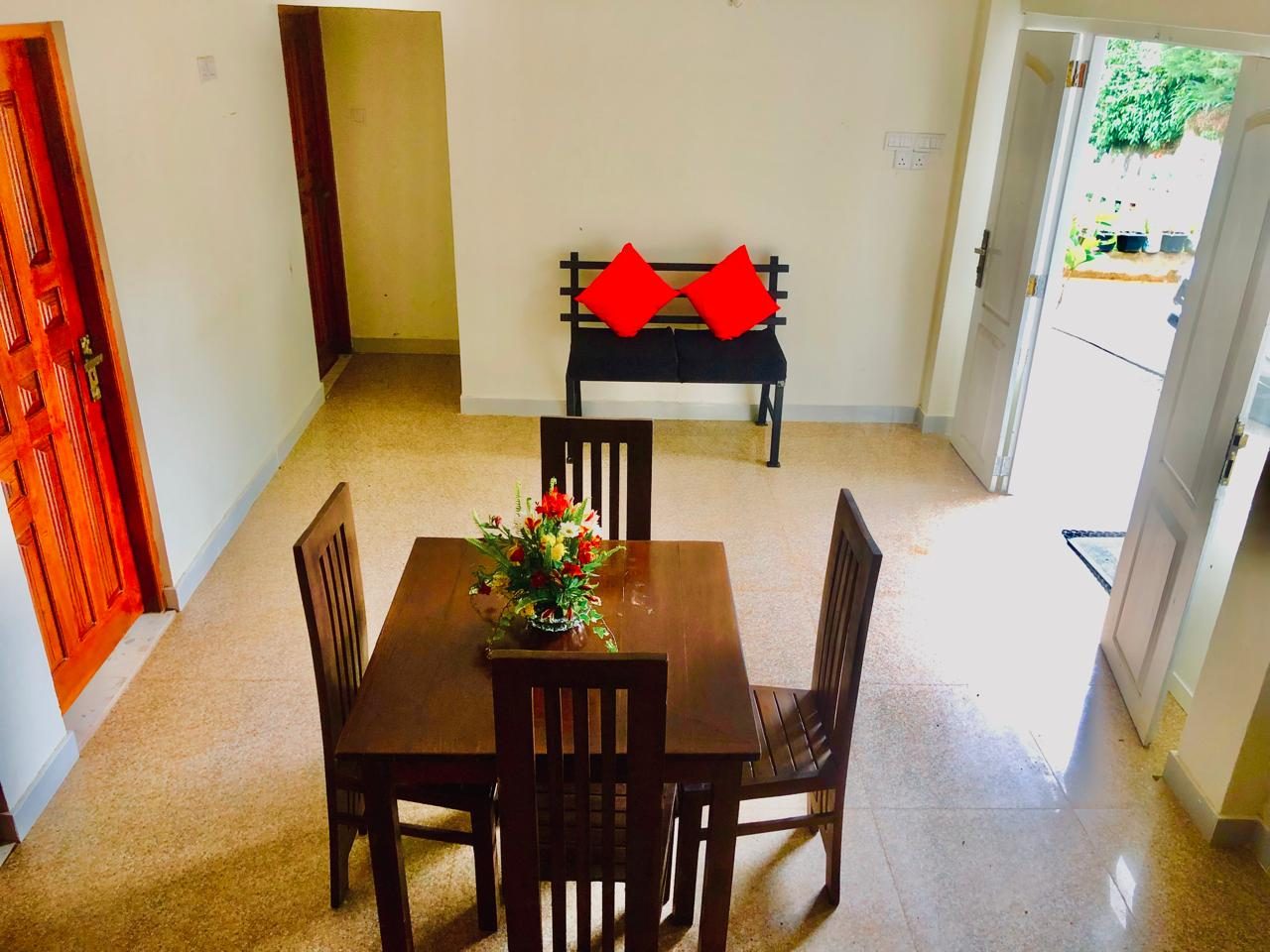 Ground-floor room with a dining table and doors to the garden