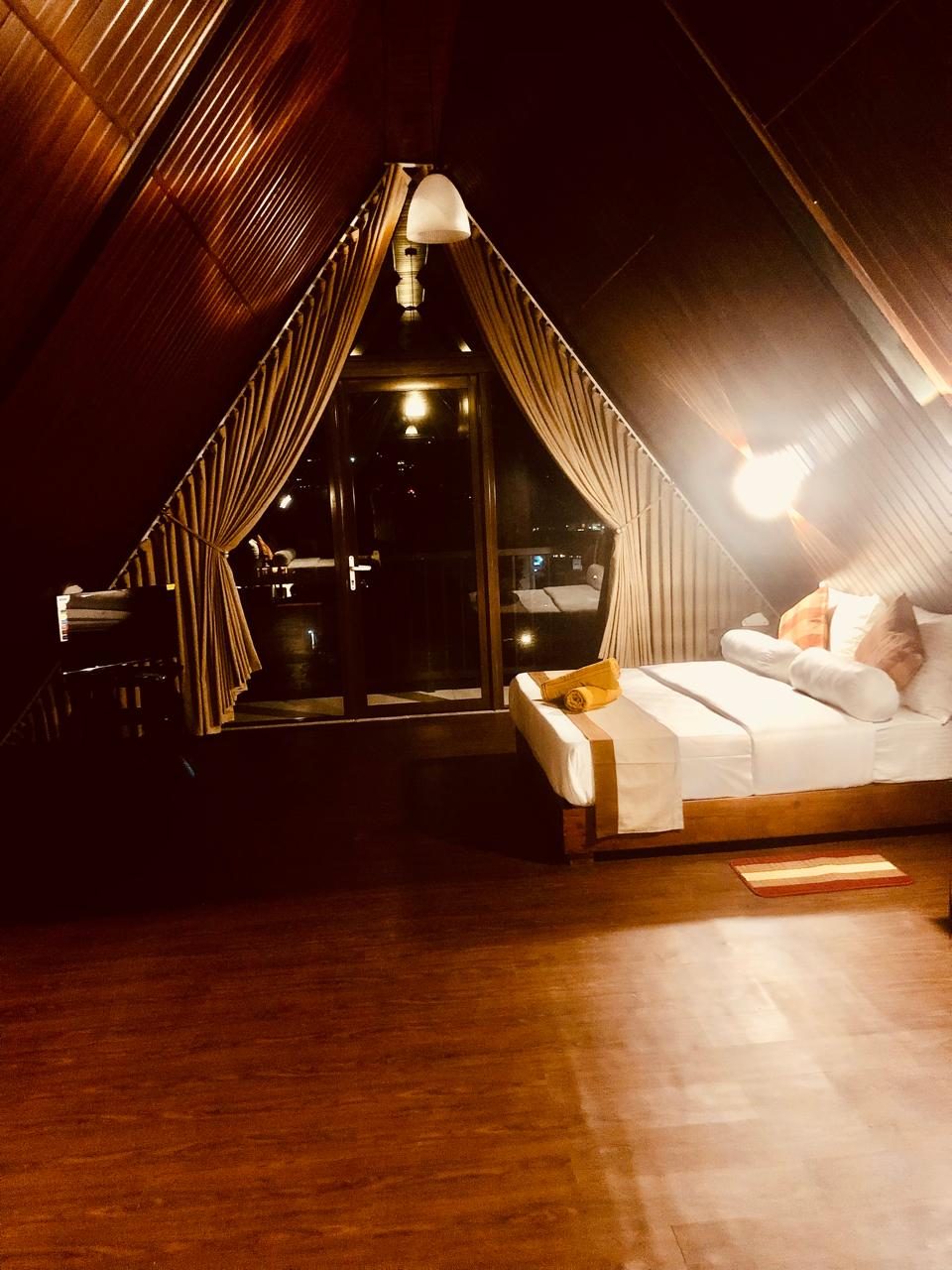 The cabana family room under the A-frame roof, with balcony doors and reading lamps