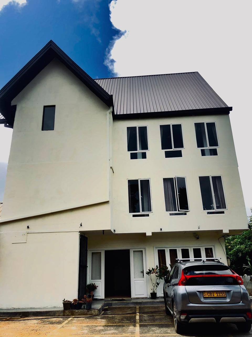 House and car park with blue sky