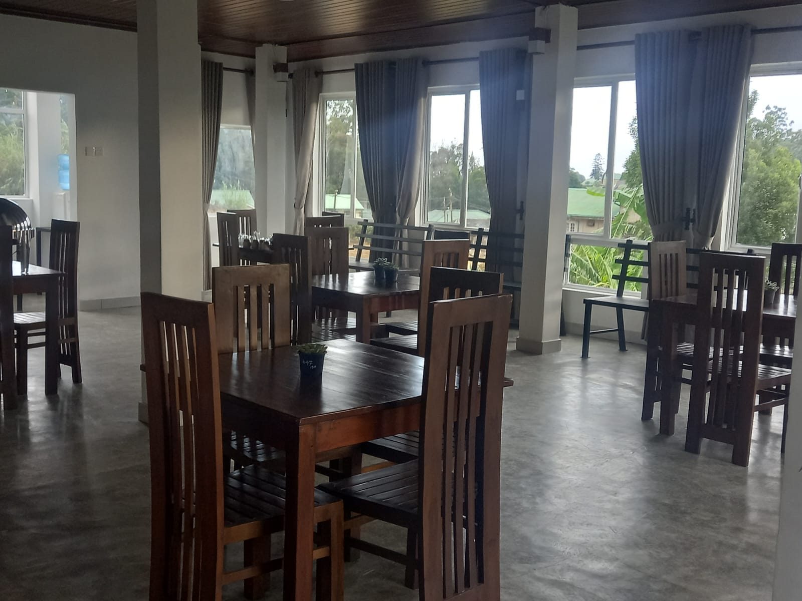 The second-floor restaurant with dark wood tables and tall windows
