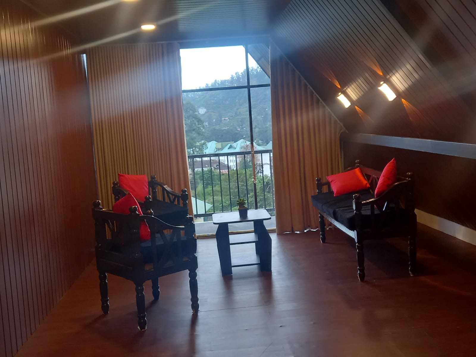 Seating by the balcony doors, panelled in timber-effect finish