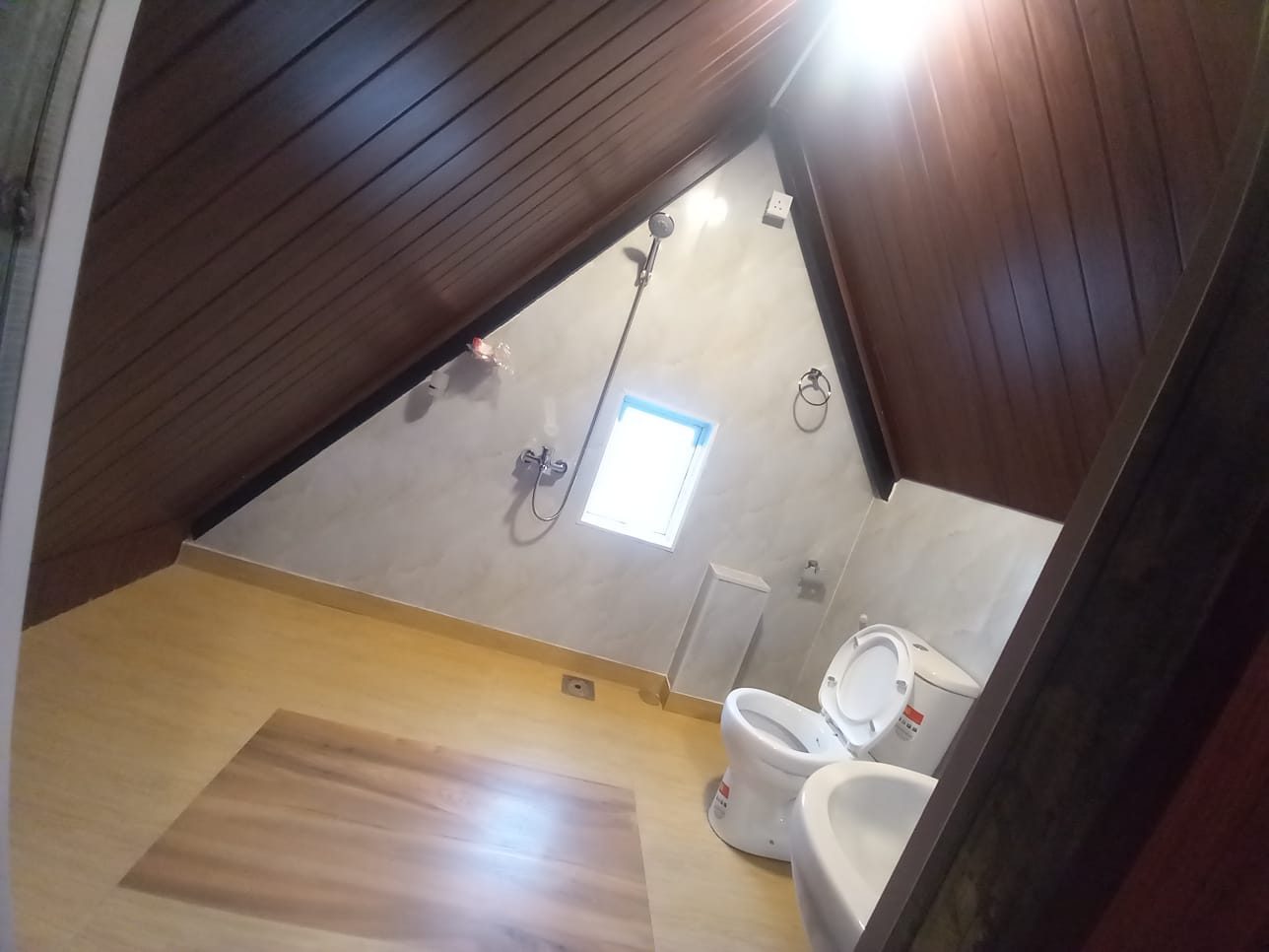 Cabana bathroom with basin, toilet and a small window