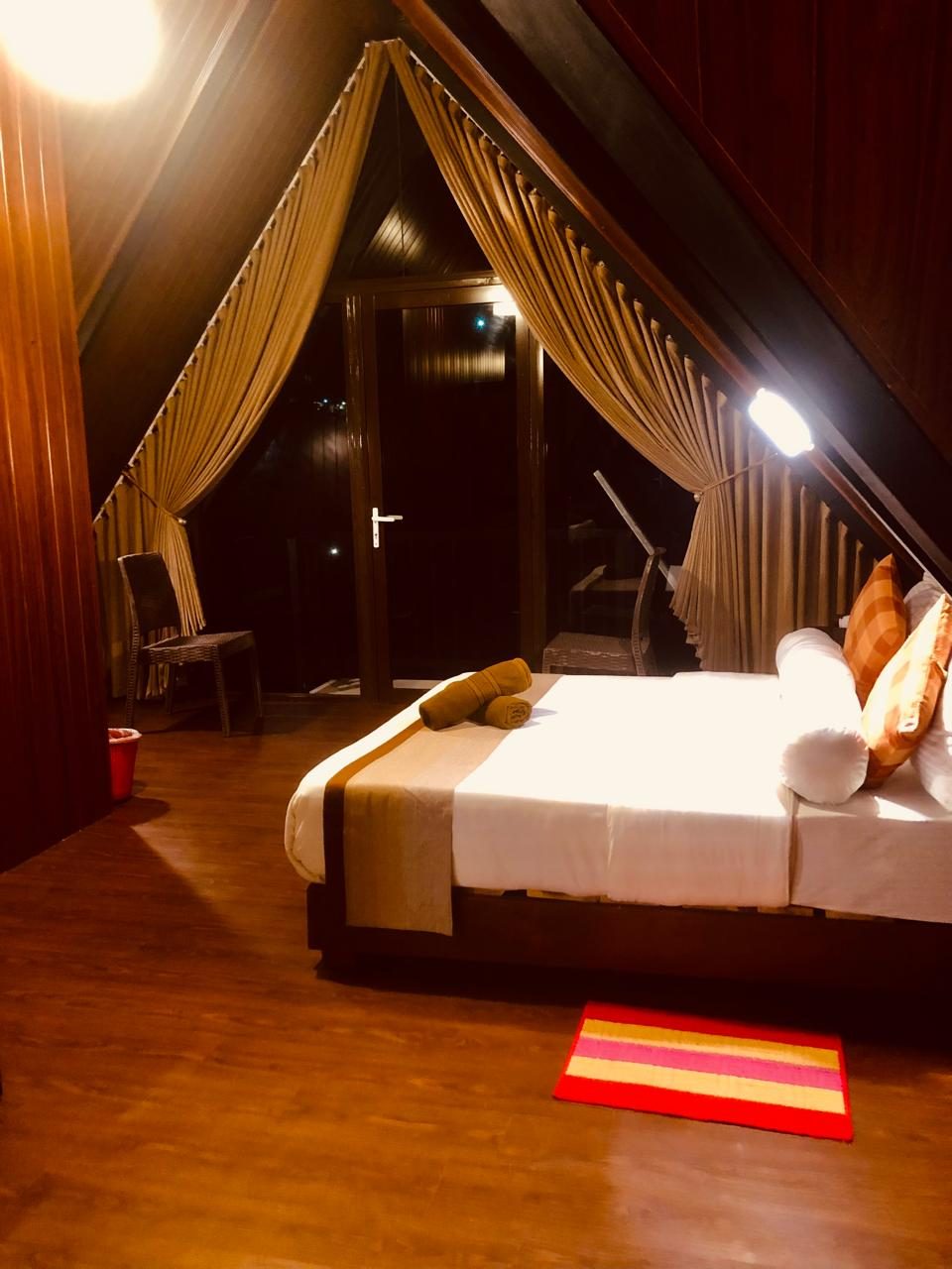 Cabana family room with the balcony doors lit at dusk