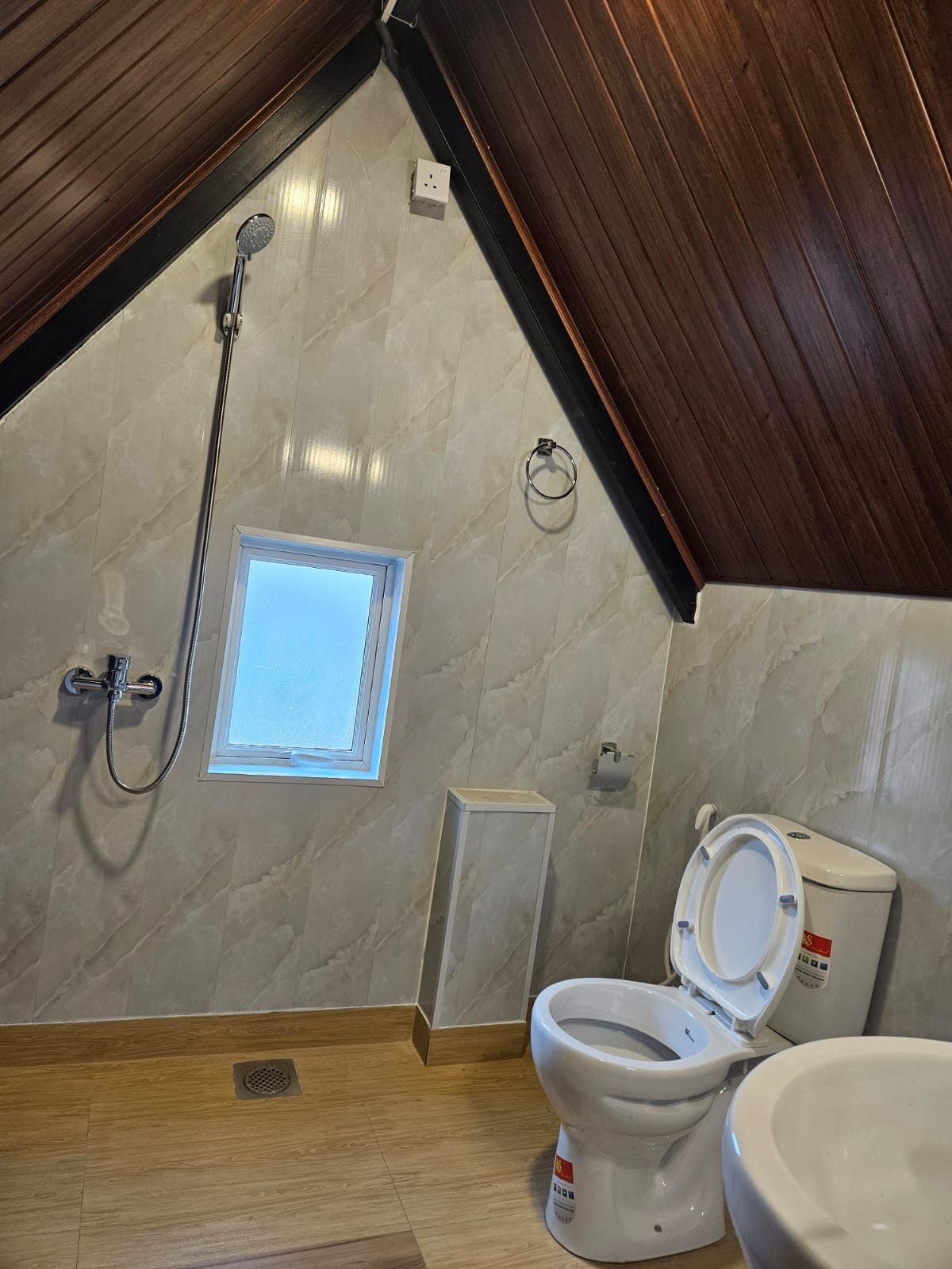 Cabana bathroom under the sloping roof with a shower